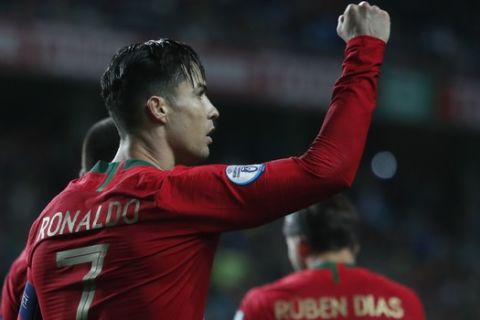 Portugal's Cristiano Ronaldo celebrates after scoring the opening goal during the Euro 2020 group B qualifying soccer match between Portugal and Lithuania at the Algarve stadium outside Faro, Portugal, Thursday, Nov. 14, 2019. (AP Photo/Armando Franca)