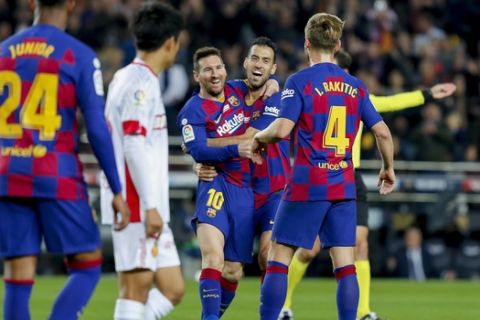 Barcelona's Lionel Messi, center left, celebrates with Sergio Busquets after scoring his side's second goal during a Spanish La Liga soccer match between Barcelona and Mallorca at Camp Nou stadium in Barcelona, Spain, Saturday, Dec. 7, 2019. (AP Photo/Joan Monfort)