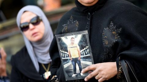 An Egyptian woman holds a portrait of a family member and a victim of the Port Said massacre outside the Court of Cassation following the court's ruling in the case, in Cairo, on February 20, 2017. An Egyptian court upheld death sentences against 10 people convicted over rioting that claimed 74 lives at a stadium in Port Said in 2012, judicial and security officials said. The riot, the country's deadliest sports-related violence, broke out when fans of home team Al-Masry and Cairo's Al-Ahly clashed after a premier league match between the two clubs.  / AFP PHOTO / MOHAMED EL-SHAHED