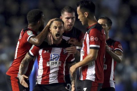 Southampton's Danny Ings, second from left, celebrates with teammates after scoring his side's first goal during an English League Cup soccer match between at Southampton and Portsmouth at Fratton Park, Tuesday, Sept. 24, 2019, Portsmouth, England. (Andrew Matthews/PA via AP)