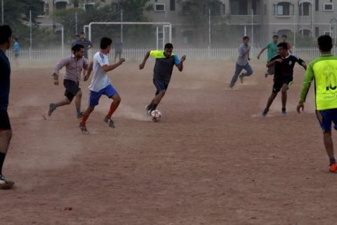 Pakistani youth play soccer at a dusty ground in Islamabad, Pakistan, Wednesday, Oct. 11, 2017. FIFA suspended Pakistan from international soccer on Wednesday because of government interference after disputed national federation elections. The Pakistan soccer federation's "offices and its accounts remain in control of a court-appointed administrator," FIFA said. (AP Photo/Anjum Naveed)