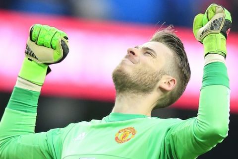 Uniteds goalkeeper David de Gea celebrates after his team won the English Premier League soccer match between Manchester City and Manchester United at the Etihad stadium in Manchester, Sunday, March 20, 2016.(AP Photo/Jon Super)