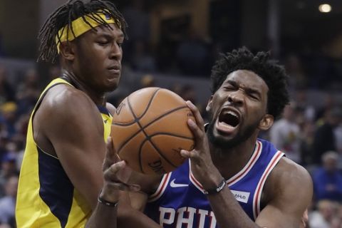 Philadelphia 76ers' Joel Embiid is fouled by Indiana Pacers' Myles Turner during the first half of an NBA basketball game, Wednesday, Nov. 7, 2018, in Indianapolis. (AP Photo/Darron Cummings)