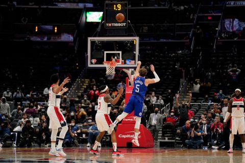 Los Angeles Clippers guard Luke Kennard (5) hits the game tying shot during the second half of an NBA basketball game against the Washington Wizards, Tuesday, Jan. 25, 2022, in Washington. The Clippers erased a 35 point deficit to defeat the Wizards 116-115. (AP Photo/Evan Vucci)