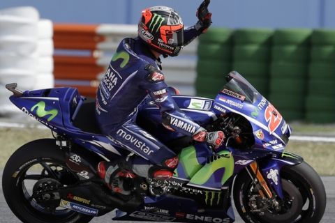 Yamaha rider Maverick Vinales, of Spain, waves his fans after taking the pole position during the qualifying session for Sunday's San Marino Moto GP race, at the Misano circuit, in Misano Adriatico, Italy, Saturday, Sept. 9, 2017. (AP Photo/Antonio Calanni)
