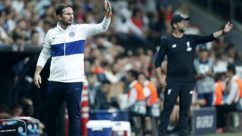 Chelsea's head coach Frank Lampard , left, and Liverpool's manager Jurgen Klopp gesture during the UEFA Super Cup soccer match between Liverpool and Chelsea, in Besiktas Park, in Istanbul, Wednesday, Aug. 14, 2019.(AP Photo/Lefteris Pitarakis)