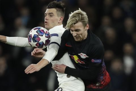 Tottenham's Giovani Lo Celso, left, fights for the ball with Leipzig's Emil Forsberg during a first leg, round of 16, Champions League soccer match between Tottenham Hotspur and Leipzig at the Tottenham Hotspur Stadium in London, England, Wednesday Feb. 19, 2020. (AP Photo/Matt Dunham)