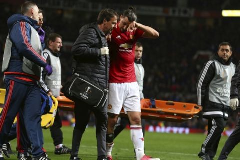 Manchester United's Zlatan Ibrahimovic, center right, leaves the field with an injury during the Europa League quarterfinal second leg soccer match between Manchester United and Anderlecht at Old Trafford stadium, in Manchester, England, Thursday, April 20, 2017. (AP Photo/Dave Thompson)