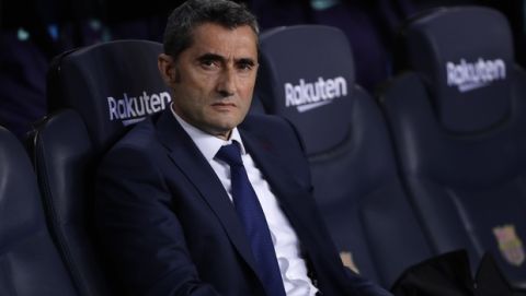 Barcelona coach Ernesto Valverde takes his seat prior to a Spanish La Liga soccer match between FC Barcelona and Atletico Madrid at the Camp Nou stadium in Barcelona, Spain, Saturday April 6, 2019. (AP Photo/Manu Fernandez)