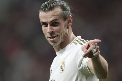 FILE - In this Saturday, Sept. 28, 2019 file photo, Real Madrid's Gareth Bale gestures during the Spanish La Liga soccer match between Atletico Madrid and Real Madrid at the Wanda Metropolitano stadium in Madrid. The immediate future of Gareth Bale is once again in doubt after he travelled to London with permission of Real Madrid to see his agent this week. That reignited speculation about a possible departure after his coach said in July that it would best for player and club to part ways. Zinedine Zidane has since backtracked and said that Bale is an important player for him, but the damage was done to the public image of their relationship. (AP Photo/Bernat Armangue, File)