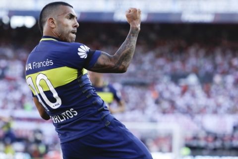 FILE - In this Dec. 11, 2016 file photo, Boca Juniors' forward Carlos Tevez celebrates scoring against River Plate during a local tournament soccer match in Buenos Aires, Argentina. Tevez agreed on Friday, Jan. 5, 2018, to return to Boca Juniors after a tumultuous period with Shanghai Shenhua in the Chinese Super League. (AP Photo/Natacha Pisarenko, File)