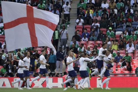 England's Gary Cahill, second from right, celebrates with his teammates after scoring the opening goal during a friendly soccer match between England and Nigeria at Wembley stadium in London, Saturday, June 2, 2018. (AP Photo/Matt Dunham)