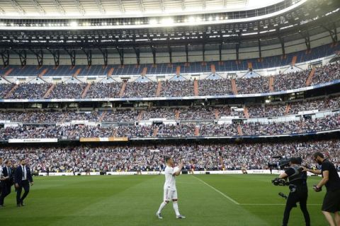 Belgium forward Eden Hazard claps to supporters during his official presentation after signing for Real Madrid at the Santiago Bernabeu stadium in Madrid, Spain, Thursday, June 13, 2019. Real Madrid announced last week that it had acquired the 28-year-old Belgian playmaker from Chelsea for a reported fee of around 100 million euros ($113 million) plus variables, making him the club's most expensive signing ever. (AP Photo/Manu Fernandez)
