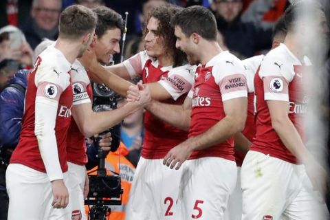 Arsenal's Laurent Koscielny, second left celebrates with teammates after scoring his sides2nd goal during the English Premier League soccer match between Arsenal and Chelsea at the Emirates stadium in London, Saturday, Jan. 19, 2019. (AP Photo/Frank Augstein)