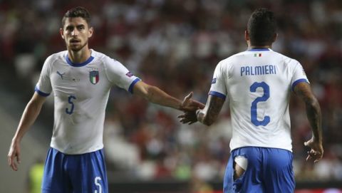 Italy's Emerson Palmieri , right, passes Jorginho as he runs to change his shorts that ripped during the UEFA Nations League soccer match between Portugal and Italy at the Luz stadium in Lisbon, Monday, Sept. 10, 2018. (AP Photo/Armando Franca)
