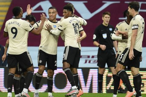 Manchester United's Mason Greenwood celebrates with teammates after scoring his team's second goal during the English Premier League soccer match between Aston Villa and Manchester United at Villa Park in Birmingham, England, Thursday, July 9, 2020. (AP Photo/Oli Scarff,Pool)
