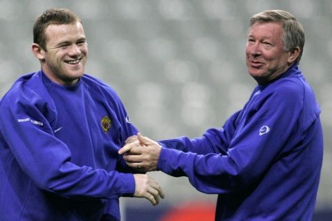 Wayne Rooney of Manchester United, left, jokes with his coach Alex Ferguson during a training session at the Stade de France stadium, outside Paris, Tuesday, Nov. 1, 2005. Lille will face Manchester United Wednesday in a European Champions League match.  (AP Photo/Christophe Ena)