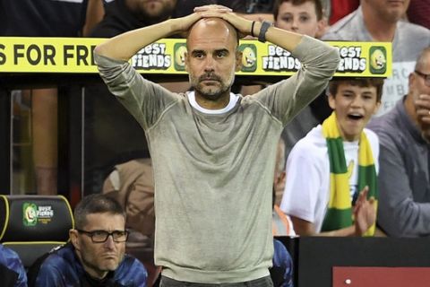 Manchester City manager Pep Guardiola looks dejected on the touchline during the English Premier League soccer match between Norwich City and Manchester City at Carrow Road, Norwich, England, Saturday, Sept. 14, 2019. (Joe Giddens/PA via AP)