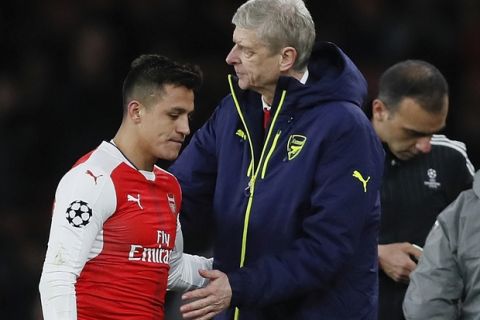 Arsenal's Alexis Sanchez, left, hugs with Arsenal manager Arsene Wenger during the Champions League round of 16 second leg soccer match between Arsenal and Bayern Munich at the Emirates Stadimum in London, Tuesday, March 7, 2017. (AP Photo/Kirsty Wigglesworth)