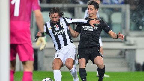 Celtic's defender Beram Kayal (R) fights for the ball with Juventus' midfielder Andrea Pirlo (L) during the Champions League match Juventus vs Celtic FC on March 6, 2013   at the "Juventus Stadium" in Turin.   AFP PHOTO / GIUSEPPE CACACE        (Photo credit should read GIUSEPPE CACACE/AFP/Getty Images)