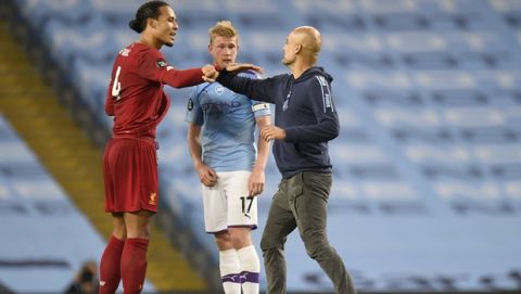 Manchester City's head coach Pep Guardiola gestures with Liverpool's Virgil van Dijk, left, as Manchester City's Kevin De Bruyne, centre, looks on after the English Premier League soccer match between Manchester City and Liverpool at Etihad Stadium in Manchester, England, Thursday, July 2, 2020. (AP Photo/Peter Powell,Pool)