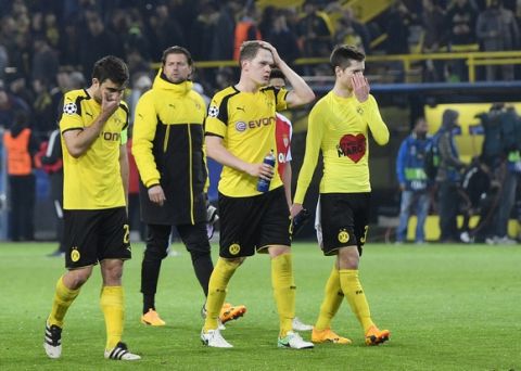 Dortmund's Sokratis Papastathopoulos, Roman Weidenfeller, Matthias Ginter and Julian Weigl, from left, react after losing 2-3 during the Champions League quarterfinal first leg soccer match between Borussia Dortmund and AS Monaco in Dortmund, Germany, Wednesday, April 12, 2017. (AP Photo/Martin Meissner)