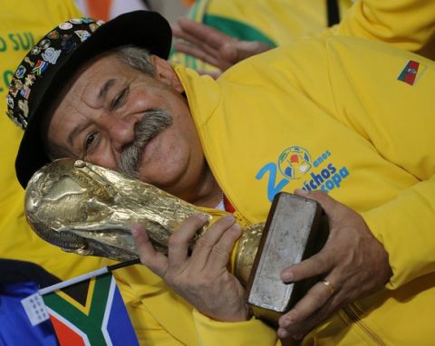 A Brazil supporter holds a mock-up trophy as he cheers prior to the start of the Group G first round 2010 World Cup football match Brazil vs. Ivory Coast on June 20, 2010 at Soccer City stadium in Soweto, suburban Johannesburg. NO PUSH TO MOBILE / MOBILE USE SOLELY WITHIN EDITORIAL ARTICLE  -      AFP PHOTO / PEDRO UGARTE (Photo credit should read PEDRO UGARTE/AFP/Getty Images)