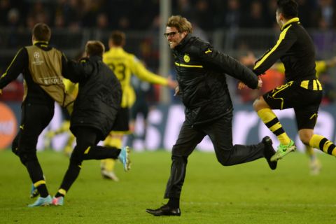 Dortmund's head coach Juergen Klopp celebrates with his players after the UEFA Champions League quarter-final second-leg football match of Borussia Dortmund vs Malaga CF in Dortmund, western Germany on April 9, 2013. Dortmund won the match 3-2 and qualified for the semi-finals.    AFP PHOTO / PATRIK STOLLARZ        (Photo credit should read PATRIK STOLLARZ/AFP/Getty Images)