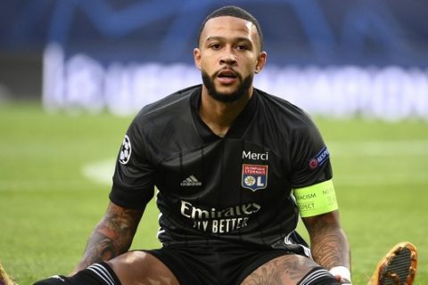 Lyon's Memphis Depay reacts after missing a chance to score during the Champions League semifinal soccer match between Lyon and Bayern at the Jose Alvalade stadium in Lisbon, Portugal, Wednesday, Aug. 19, 2020. (Franck Fife/Pool via AP)