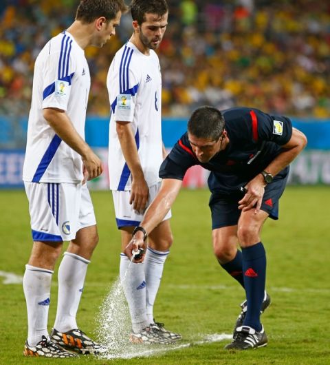 CUIABA, BRAZIL - JUNE 21:  Referee Peter O'Leary sprays a temporary line for a free kick as Bosnia and Herzegovina forms a wall during the 2014 FIFA World Cup Group F match between Nigeria and Bosnia-Herzegovina at Arena Pantanal on June 21, 2014 in Cuiaba, Brazil.  (Photo by Phil Walter/Getty Images)