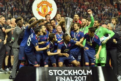 United's Wayne Rooney, center, lifts the trophy after winning the soccer Europa League final between Ajax Amsterdam and Manchester United at the Friends Arena in Stockholm, Sweden, Wednesday, May 24, 2017. United won 2-0. (AP Photo/Martin Meissner)