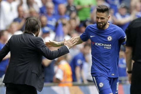 Chelsea's Olivier Giroud celebrates with Chelsea head coach Antonio Conte, left, after scoring the opening goal during the English FA Cup semifinal soccer match between Chelsea and Southampton at Wembley stadium in London, Sunday, April 22, 2018. (AP Photo/Alastair Grant)