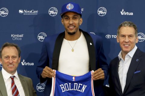 Philadelphia 76ers' draft pick Jonah Bolden, center, poses with team president Bryan Colangelo, right, and managing owner Josh Harris after a news conference at the team's NBA basketball training complex, Friday, June 23, 2017, in Camden, NJ. (AP Photo/Matt Slocum)