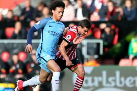 Manchester City's Leroy Sane, left, and Southampton's Cedric Soares battle for the ball during the English Premier League soccer match at St Mary's Stadium, Southampton, England, Saturday April 15, 2017. (Steven Paston/PA via AP)