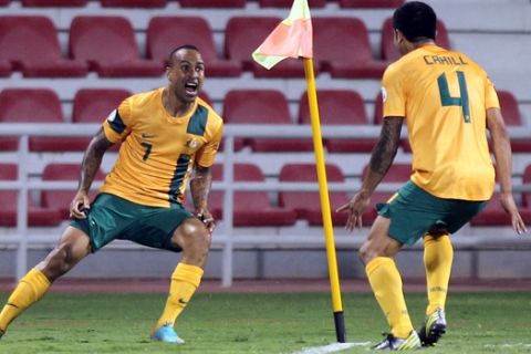 Archie Thompson of Australia, left, celebrates a goal with Tim Cahill during the 2014 FIFA World Cup Qualifier match between Iraq and Australia in Doha, Qatar, Tuesday Oct. 16, 2012. (AP Photo/Osama Faisal)  