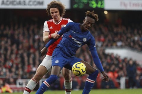 Chelsea's Tammy Abraham, right, challenges for the ball with Arsenal's David Luiz during the English Premier League soccer match between Arsenal and Chelsea, at the Emirates Stadium in London, Sunday, Dec. 29, 2019. (AP Photo/Ian Walton)