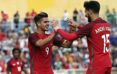 Portugal's Andre Silva celebrates with Andre Gomes, right, after scoring his side's fourth goal during the international friendly soccer match between Portugal and Cyprus in Estoril, outside Lisbon, Saturday, June 3 2017. (AP Photo/Armando Franca)