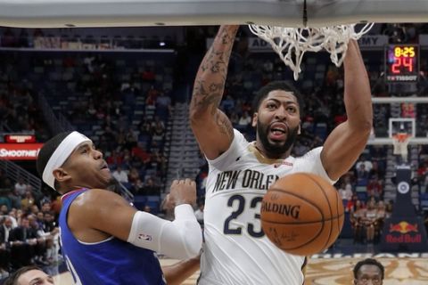 New Orleans Pelicans forward Anthony Davis (23) slam dunk over Los Angeles Clippers forward Tobias Harris and forward Danilo Gallinari, left, in the first half of an NBA basketball game in New Orleans, Tuesday, Oct. 23, 2018. (AP Photo/Gerald Herbert)