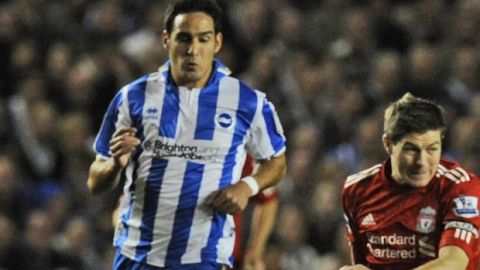 Brighton and Hove Albion's Vicente, left, closes in on Liverpool's Steven Gerrard during their third round English League Cup soccer match at the Amex  stadium, Brighton, Wednesday, Sept. 21, 2011. (AP Photo/Tom Hevezi)