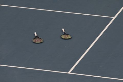Rackets of Australia's Alex De Minaur and Nick Kyrgios are left after they beat Britain's Jamie Murray and Joe Salisbury during their ATP Cup tennis doubles match in Sydney, Thursday, Jan. 9, 2020. (AP Photo/Steve Christo)