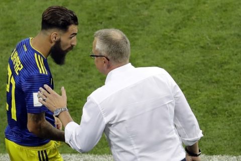 Sweden's head coach Janne Andersson, right, converses with player Jimmy Durmaz during the group F match between Germany and Sweden at the 2018 soccer World Cup in the Fisht Stadium in Sochi, Russia, Saturday, June 23, 2018. (AP Photo/Sergei Grits)