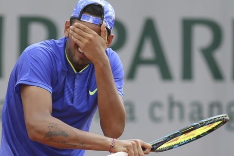 Australia's Nick Kyrgios gestures after missing a shot against South Africa's Kevin Anderson during their second round match of the French Open tennis tournament at the Roland Garros stadium, in Paris, France. Thursday, June 1, 2017. (AP Photo/David Vincent)