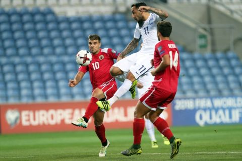 Greece's Kostas Mitroglou, center, scores the opening goal during the World Cup Group H qualifying soccer match between Gibraltar and Greece outside Faro, southern Portugal, Tuesday, Sept. 6, 2016. (AP Photo/Armando Franca)