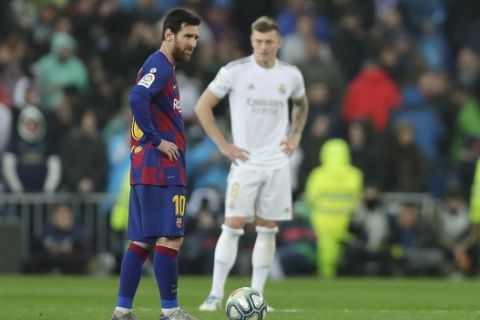 Barcelona's Lionel Messi, left, reacts after Real Madrid's Mariano Diaz scored his side's second goal during the Spanish La Liga soccer match between Real Madrid and Barcelona at the Santiago Bernabeu stadium in Madrid, Spain, Sunday, March 1, 2020. (AP Photo/Manu Fernandez)