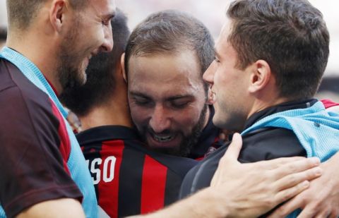 AC Milan's Gonzalo Higuain, second from right, celebrates with his teammates after scoring his side's opening goal during the Serie A soccer match between AC Milan and Chievo Verona at the San Siro Stadium, in Milan, Italy, Sunday, Oct. 7, 2018. (AP Photo/Antonio Calanni)