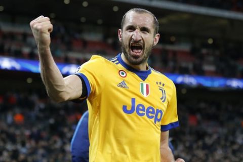 FILE - In this  Wednesday, March 7, 2018 filer, Juventus' Giorgio Chiellini celebrates at the end of a the Champions League, round of 16, second-leg soccer match between Juventus and Tottenham Hotspur, at the Wembley Stadium in London. The Juventus captain -- who has a masters degree in business administration -- was the main go-between for millionaire teammates like Cristiano Ronaldo and management when the squad agreed to forgo 90 million euros ($100 million) in wages to help the club during the coronavirus crisis. (AP Photo/Frank Augstein, File)