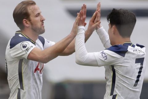 Tottenham's Harry Kane, left, celebrates after scoring his side's opening goal during the English Premier League soccer match between Tottenham Hotspur and Wolverhampton Wanderers at Tottenham Hotspur Stadium in London, England, Sunday, May 16, 2021. (AP Photo/Andrew Couldridge, Pool)
