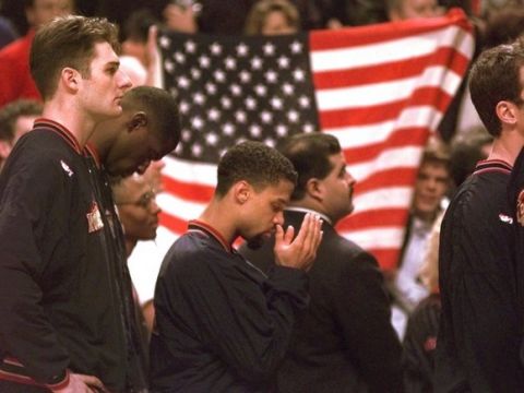 Denver Nuggets guard Mahmoud Abdul-Rauf stands with his teammates and prays during the national anthem before the game with the Chicago Bulls on Friday night, March 15, 1996, in Chicago. Abdul-Rauf, saying that the U.S. flag was a symbol of "oppression and tyranny," was suspended Tuesday for sitting down during the national anthem. Friday was Abdul-Rauf's first game back. The Bulls went on to beat the Nuggets 108-87.  (AP Photo/Michael S. Green)