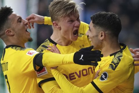 Dortmund's Erling Haaland, center, celebrates scoring a goal against Werder Bremen during the German Bundesliga soccer match in Bremen, Germany, Saturday Feb. 22, 2020. (Peter Steffen/DPA via AP)