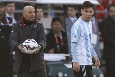 Argentina's Lionel Messi, right, walks past Chile's coach Jorge Sampaoli, left, during the Copa America final soccer match at the National Stadium in Santiago, Chile, Saturday, July 4, 2015. (AP Photo/Ricardo Mazalan)